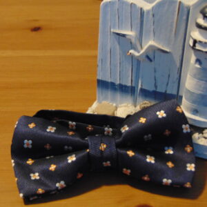 blue-navy-background-with-nice-small-two-colors-flours-self-bow-tie